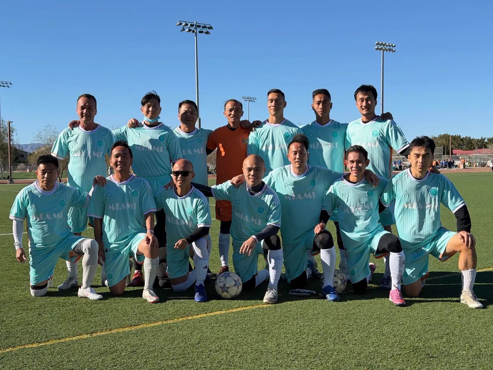 The squad lined up on the pitch in teal kit