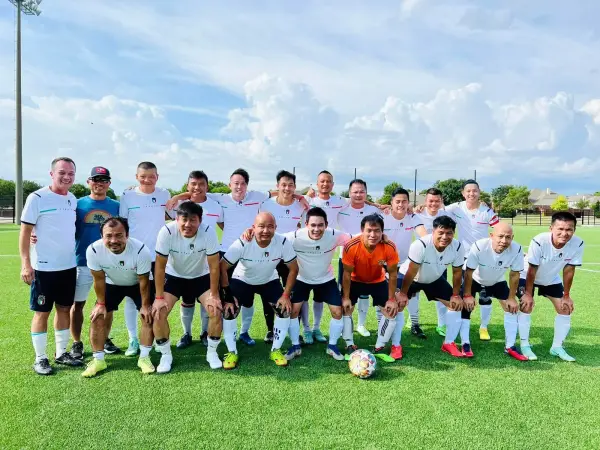 The squad in white kit on a summer afternoon
