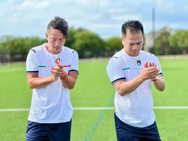 Two players applauding the supporters